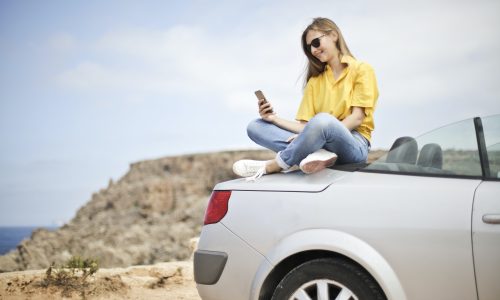 woman sitting on car